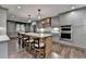 Modern kitchen featuring a central island with seating, stainless steel appliances, and gray cabinetry at 939 Flowers Xing, Lawrenceville, GA 30044