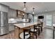 Spacious kitchen featuring a large island with seating, stainless steel appliances, and gray cabinets at 939 Flowers Xing, Lawrenceville, GA 30044