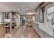 Open-concept kitchen featuring hardwood floors, modern cabinets, and a view into the dining area at 939 Flowers Xing, Lawrenceville, GA 30044