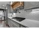 The kitchen features gray cabinets, a gas range, and stainless steel appliances at 939 Flowers Xing, Lawrenceville, GA 30044