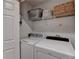 The laundry room includes shelving and is equipped with a Whirlpool washer and dryer at 939 Flowers Xing, Lawrenceville, GA 30044