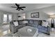 Spacious living room featuring a large sectional, an ottoman, and hardwood floors with a decorative rug at 939 Flowers Xing, Lawrenceville, GA 30044