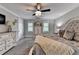 Main bedroom with neutral decor, ceiling fan, furnishings, dresser, and a view of the en suite bath at 939 Flowers Xing, Lawrenceville, GA 30044