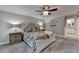 Main bedroom features neutral decor, ceiling fan, furnishings, and a glimpse of the en suite bath at 939 Flowers Xing, Lawrenceville, GA 30044