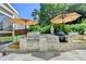 An expansive outdoor kitchen features stainless appliances, stone construction, and is ready for entertaining at 939 Flowers Xing, Lawrenceville, GA 30044