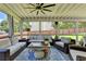 Relaxing screened porch with stylish furniture, ceiling fan, and backyard views at 939 Flowers Xing, Lawrenceville, GA 30044