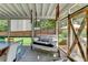 Enclosed porch features a porch swing with decorative pillows, access to outdoor views, and a custom barn door at 939 Flowers Xing, Lawrenceville, GA 30044