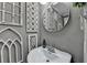 The powder room is uniquely decorated with a variety of white wall decor, vessel sink, and modern faucet at 939 Flowers Xing, Lawrenceville, GA 30044