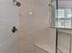 A close up of the shower with white tiled walls and brass hardware at 939 Flowers Xing, Lawrenceville, GA 30044