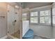 Modern glass shower with tiled walls, pebble floor, and a built-in bench at 939 Flowers Xing, Lawrenceville, GA 30044