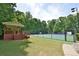 Well-maintained tennis court with a shaded viewing pavilion, ideal for enjoying a friendly match at 939 Flowers Xing, Lawrenceville, GA 30044