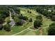 Aerial view of a home on a golf course surrounded by lush greenery and mature trees at 127 Grandmar Chase, Canton, GA 30115