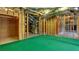 Unfinished basement with exposed framing, green flooring, and visible ductwork, ready for customization at 127 Grandmar Chase, Canton, GA 30115
