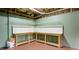 Finished basement with workbench area, pegboard, shelves and painted green walls at 127 Grandmar Chase, Canton, GA 30115