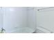 Bright white bathtub featuring tiled walls, an adjustable shower head, and a window for natural light at 127 Grandmar Chase, Canton, GA 30115