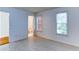 Well-lit bedroom features two windows with blinds, laminate flooring, and a door leading to a bathroom at 127 Grandmar Chase, Canton, GA 30115