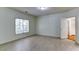 Bright bedroom with light wood flooring, large window, and a closet with shelving at 127 Grandmar Chase, Canton, GA 30115