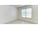 Bedroom with large window allowing ample natural light and showcasing light laminate flooring at 127 Grandmar Chase, Canton, GA 30115