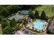 Aerial view of a community pool and tennis courts surrounded by lush greenery and parking at 127 Grandmar Chase, Canton, GA 30115