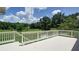 White deck overlooking green landscape and blue sky with scattered clouds at 127 Grandmar Chase, Canton, GA 30115