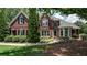 Charming brick two-story home with manicured landscaping and a welcoming front entrance at 127 Grandmar Chase, Canton, GA 30115