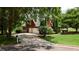 Charming brick home with a well-manicured lawn, mature trees, and a spacious driveway at 127 Grandmar Chase, Canton, GA 30115