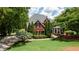 Beautiful brick home with manicured landscaping, mature trees, and a welcoming front entrance at 127 Grandmar Chase, Canton, GA 30115