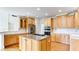 Open kitchen with a granite island, stainless appliances, and ample cabinet space at 127 Grandmar Chase, Canton, GA 30115