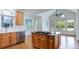 Kitchen with a granite island, stainless steel appliances, and natural light from arched windows at 127 Grandmar Chase, Canton, GA 30115
