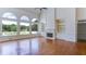 Open living room with hardwood floors, a fireplace, and floor-to-ceiling windows at 127 Grandmar Chase, Canton, GA 30115