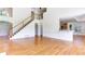 Open-concept living room boasts hardwood floors and easy access to the kitchen and staircase at 127 Grandmar Chase, Canton, GA 30115