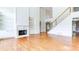 Spacious living room featuring hardwood floors, a fireplace, and built-in shelving at 127 Grandmar Chase, Canton, GA 30115