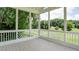Spacious screened porch with wood flooring and scenic views of the surrounding greenery at 127 Grandmar Chase, Canton, GA 30115