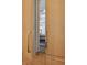 Close up of a built-in fridge in a kitchen with wood cabinets and brass handles at 1287 Star Ne Dr, Brookhaven, GA 30319