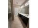 Bright bathroom with dual vanities, tile floors, and separate shower and tub at 1955 Nocturne Dr # 3105, Alpharetta, GA 30009