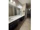 Spacious bathroom features double vanity, tile floor, and an open doorway to another room at 1955 Nocturne Dr # 3105, Alpharetta, GA 30009