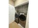 Updated laundry closet with stainless steel washer and dryer, and a stylish wallpaper at 1955 Nocturne Dr # 3105, Alpharetta, GA 30009