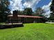 A backyard with a brick house, green grass, trees and a patio at 199 Mckaskey Creek Se Rd, Cartersville, GA 30121