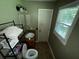Bathroom with a cabinet, a window, and a toilet at 199 Mckaskey Creek Se Rd, Cartersville, GA 30121