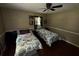 A bedroom with hardwood floors and two twin beds with floral comforters at 199 Mckaskey Creek Se Rd, Cartersville, GA 30121