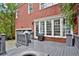 Spacious back deck with gray wooden planks, outdoor grill, and views of the landscaped yard at 49 Conifer Park Ln, Atlanta, GA 30342