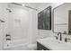 Bright, all-white bathroom features modern fixtures, a bathtub with shower, and stylish black framed art at 49 Conifer Park Ln, Atlanta, GA 30342