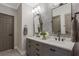 Well-lit bathroom with dual vanity, marble countertop, and decorative wall at 49 Conifer Park Ln, Atlanta, GA 30342
