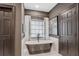 Stylish bathroom featuring a freestanding tub, modern fixtures, and textured wallpaper at 49 Conifer Park Ln, Atlanta, GA 30342