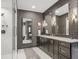 Elegant bathroom featuring dual vanities, glass shower, and updated modern fixtures at 49 Conifer Park Ln, Atlanta, GA 30342