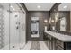Well-lit bathroom featuring a glass-enclosed shower, dual vanities, and modern fixtures at 49 Conifer Park Ln, Atlanta, GA 30342