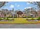 Well-manicured community with lush green spaces, elegant landscaping, and charming street lamps at 49 Conifer Park Ln, Atlanta, GA 30342