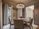 Cozy dining room with modern chandelier, gray walls, and neutral-toned furnishings at 49 Conifer Park Ln, Atlanta, GA 30342
