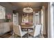 Elegant dining room featuring stylish chandelier, neutral decor, and ample natural light at 49 Conifer Park Ln, Atlanta, GA 30342