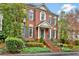 Charming brick home with lush landscaping, gray shutters, and a welcoming front entrance at 49 Conifer Park Ln, Atlanta, GA 30342